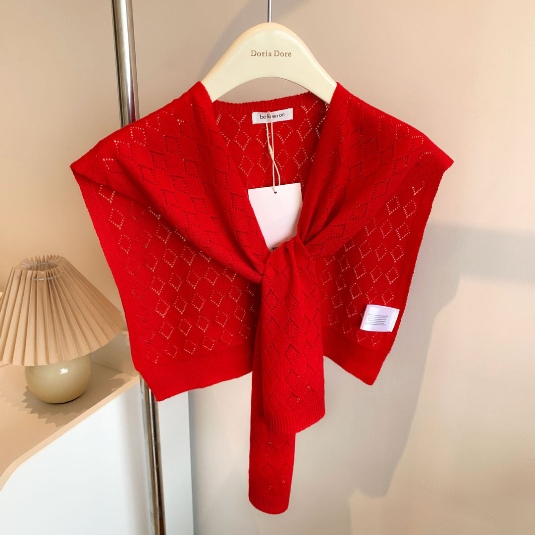 Vrouw met gebreide schouderdoek gestrikt