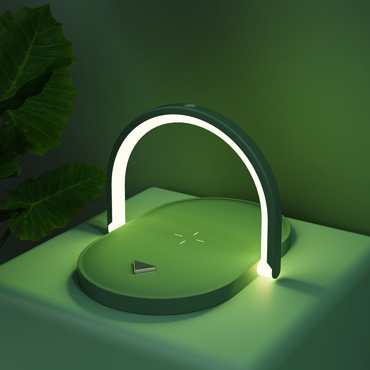 Witte bedlamp met telefoon op draadloze oplader
