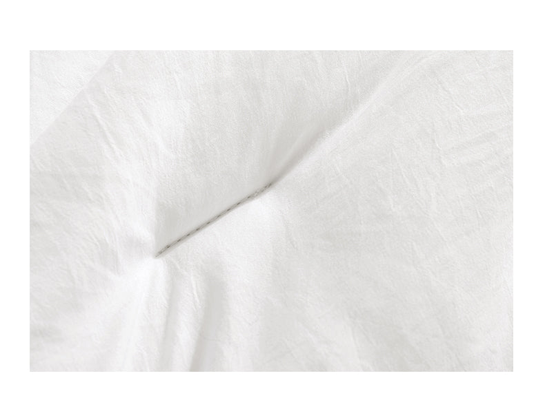Wit dekbed met vakverdeling op bed