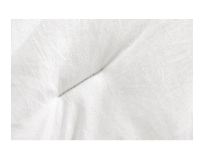 Wit dekbed met vakverdeling op bed
