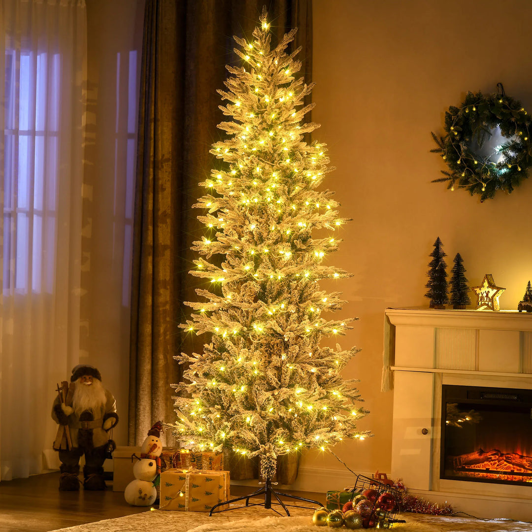 Grote besneeuwde kerstboom met heldere lampjes