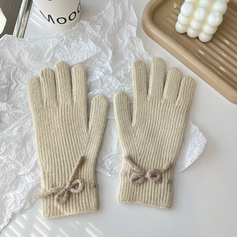 Geribde handschoenen met strikje bij de pols